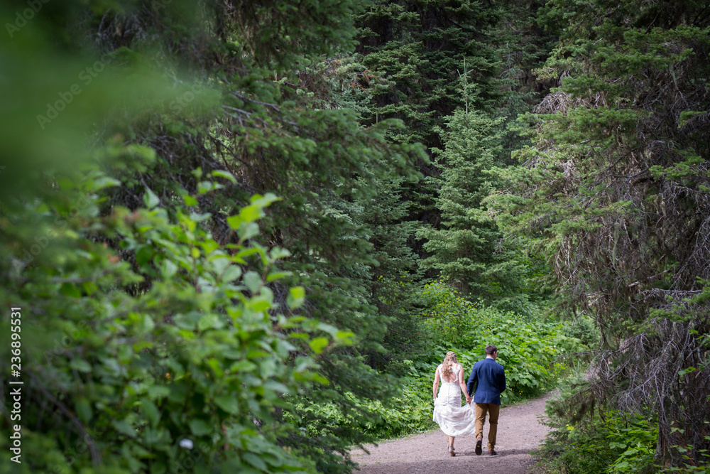 couple walking through forest couple walking through forest