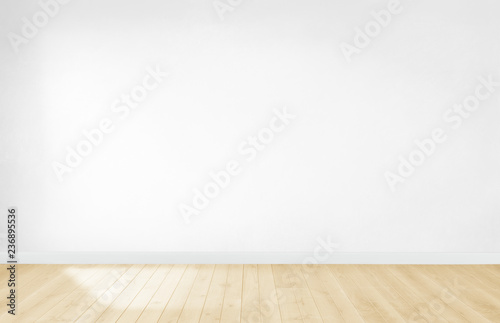 White wallpaper in an empty room with wooden floor © Rawpixel.com