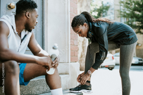 Quadro em tela Athletic girl tying her shoelaces