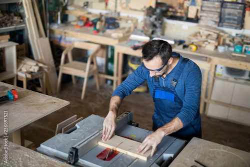 High angle portrait of mature carpenter working with wood in joinery, copy space