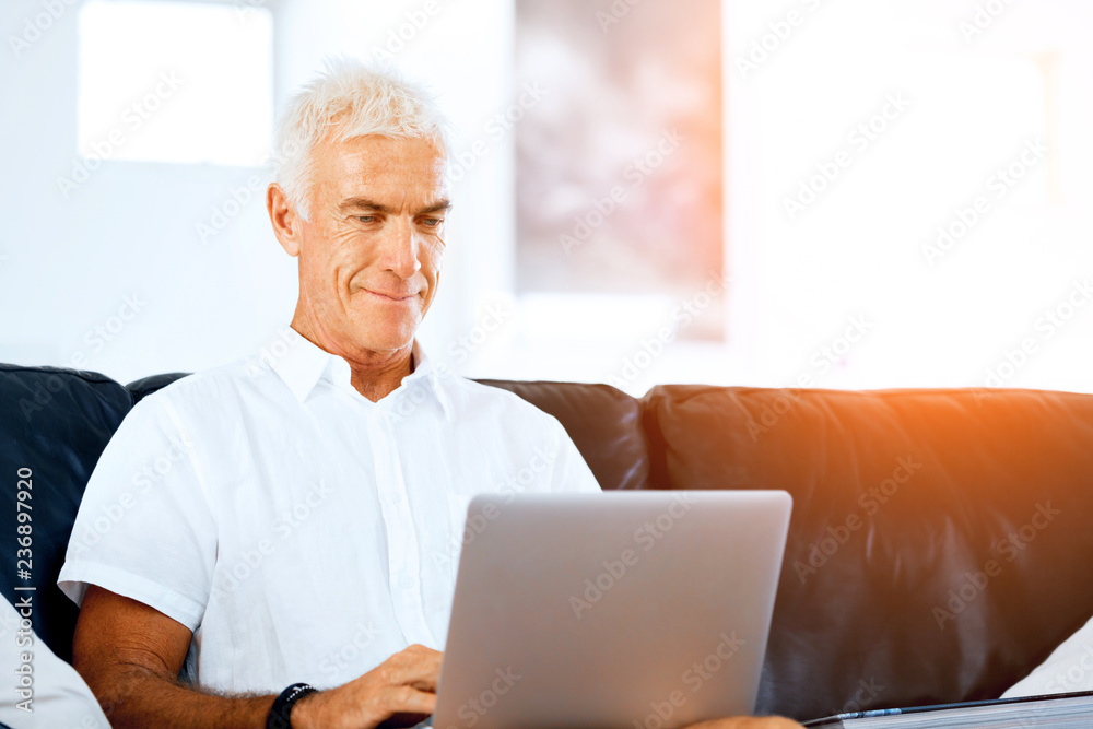 Man working on laptop at home Man working on laptop at home