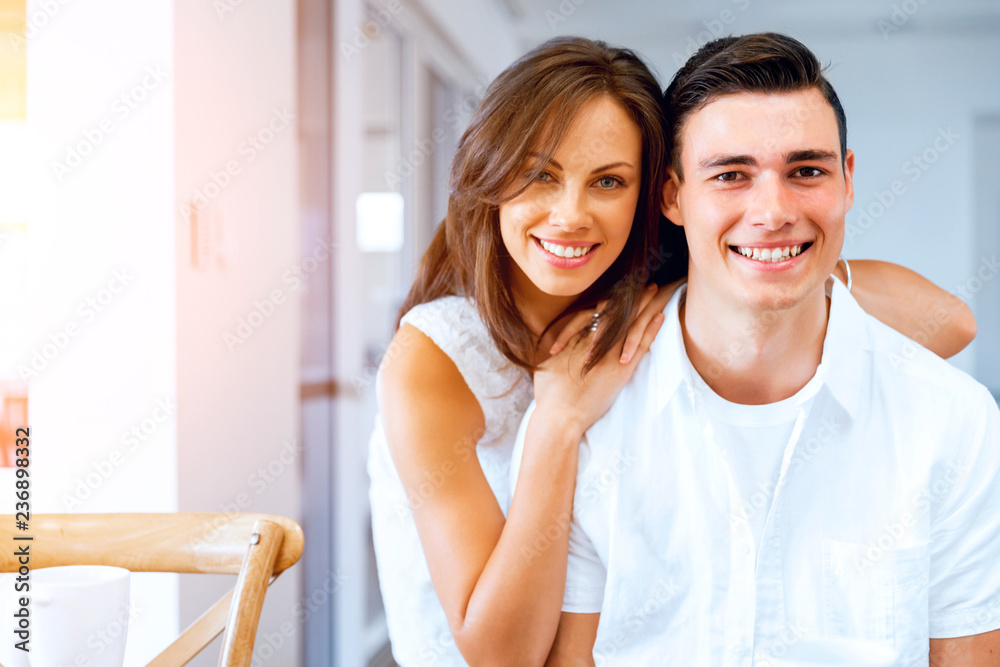 Smiling merry couple looking at camera Smiling merry couple looking at camera