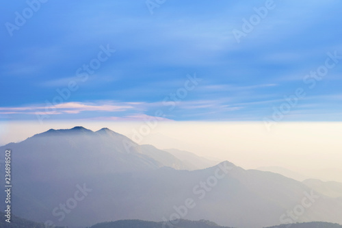 blurred for background.Blue sky background with white clouds at sunset.Mist in the sunset on the mountain.