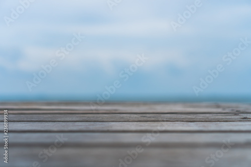 Selective focus of old wood table with blur beautiful beach background for display your product.