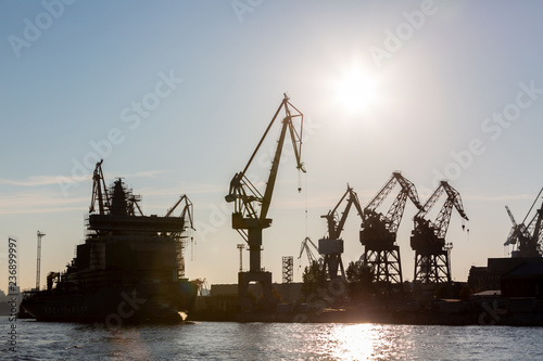 Silhouette shipyard have crane machine, Shipyard industry.