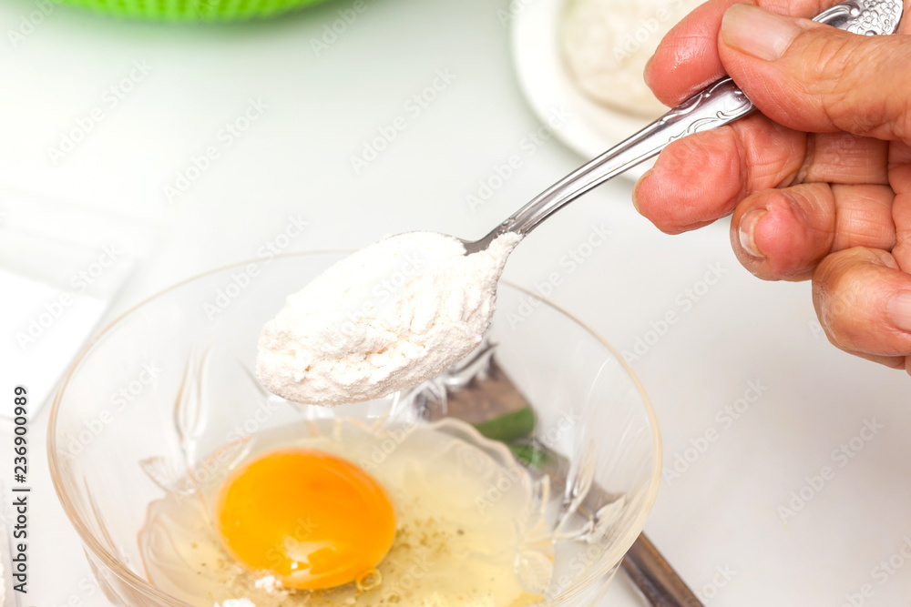 Preparation steps of traditional Colombian dish called stuffed potatoes: Preparing the egg and flour mixture to dunk potatoes