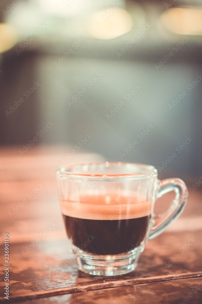 Black coffee or Americano on table with film vintage tone background. Black coffee or Americano on table with film vintage tone background.