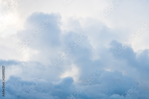 Fototapeta Naklejka Na Ścianę i Meble -  Dramatic dark cloudy sky, clouds backlit by sun moving across the sky, nature background