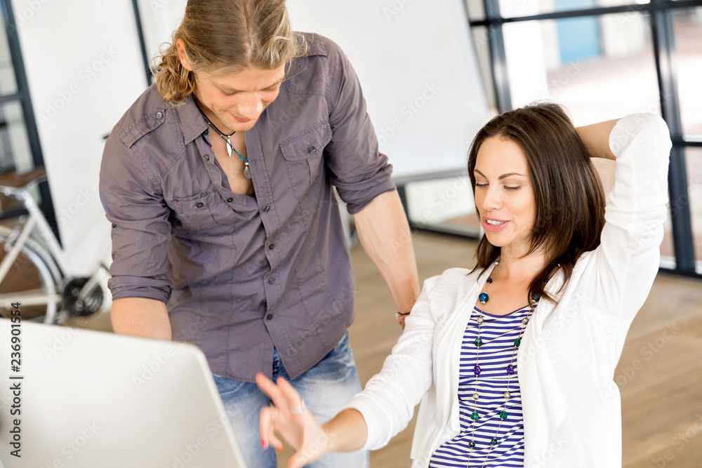 Image of two young business people in office Image of two young business people in office
