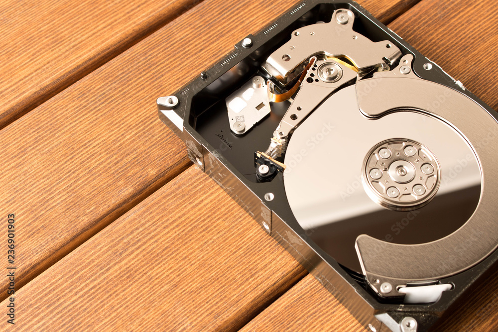 Disassembled hard drive . On the wooden table. Disassembled hard drive . On the wooden table.