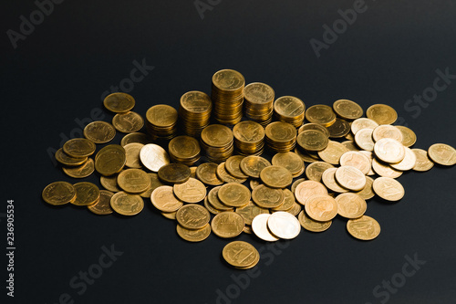 Savings  increasing columns of coins  piles of coins arranged as a graph in dark room  business banking concept.