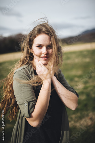 Wind blows woman's long hair outside