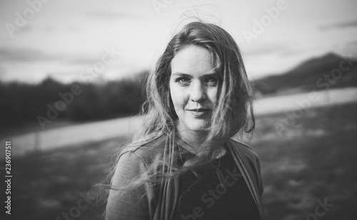 Wind blows woman's long hair, black and white