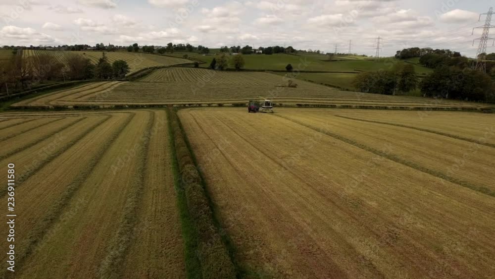 Aerial View Harvester & Tractor Working in Field Aerial View Harvester & Tractor Working in Field