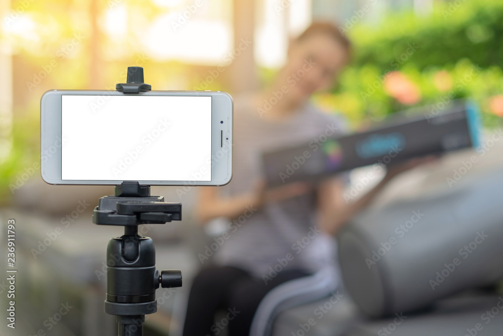 Blank screen Smart Phone on tripod shooting owner business woman work at home.E-Commerce online shopping social network entrepreneur concept. Blank screen Smart Phone on tripod shooting owner business woman work at home.E-Commerce online shopping social network entrepreneur concept.