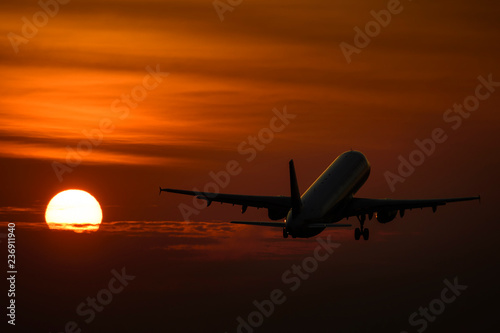 Plane take off in evening with sunset