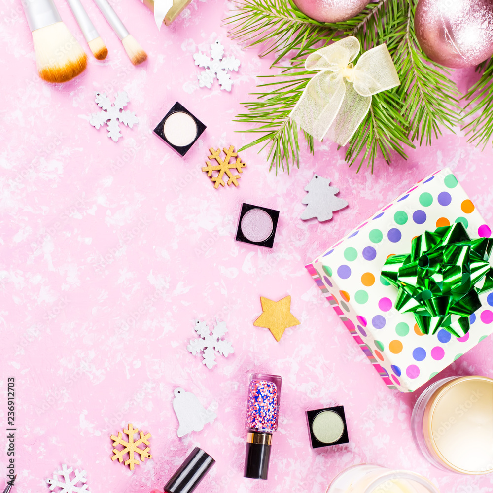 Make up cosmetics, presents and Christmas decorations on artistic pink background, copy space Make up cosmetics, presents and Christmas decorations on artistic pink background, copy space