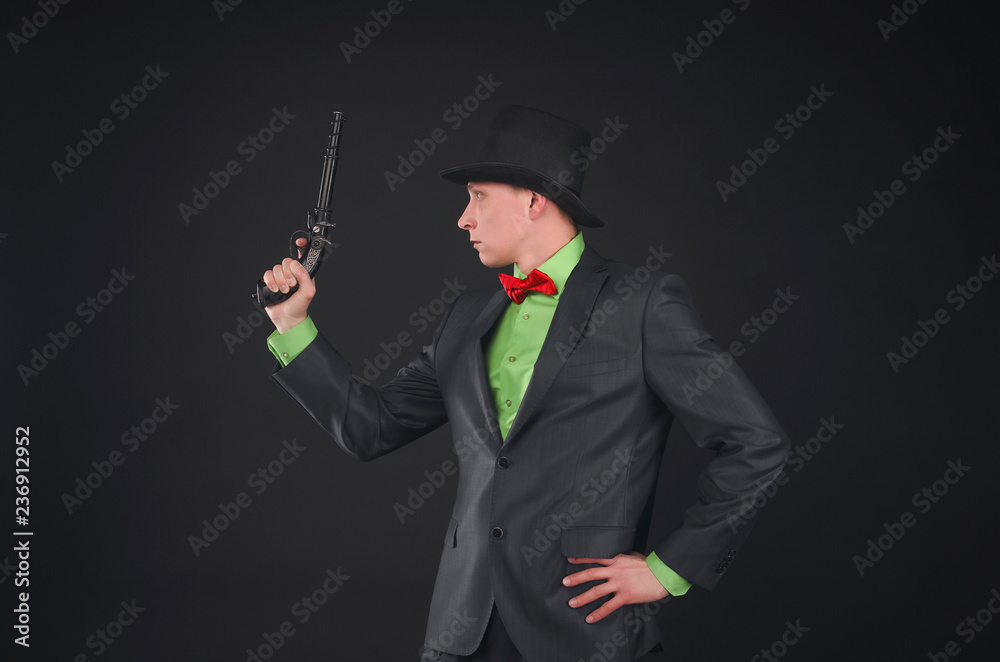 Retro style detective agent with gun and bowler hat on his head isolated on the black background. Retro style detective agent with gun and bowler hat on his head isolated on the black background.