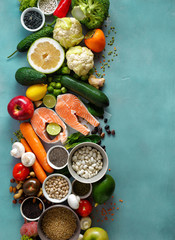 healthy food diet cereals seeds fish vegetables fruits stone background top view