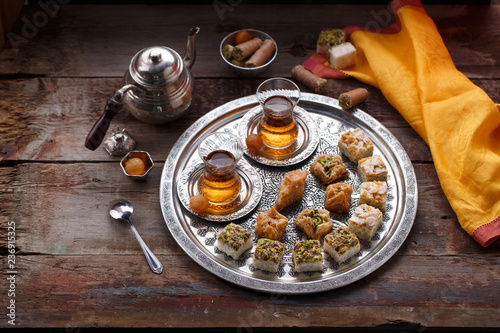 Traditional Turkish tea with oriental sweets, rustic copy space.
