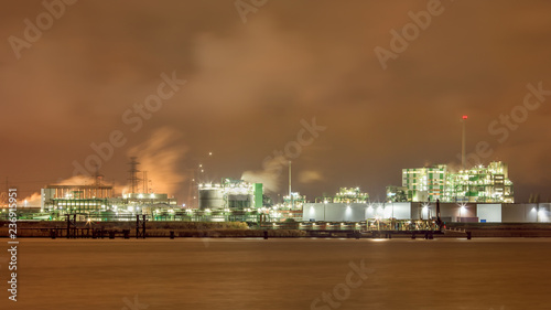 Harbor area with Illuminated petrochemical production plant, Port of Antwerp, Belgium.