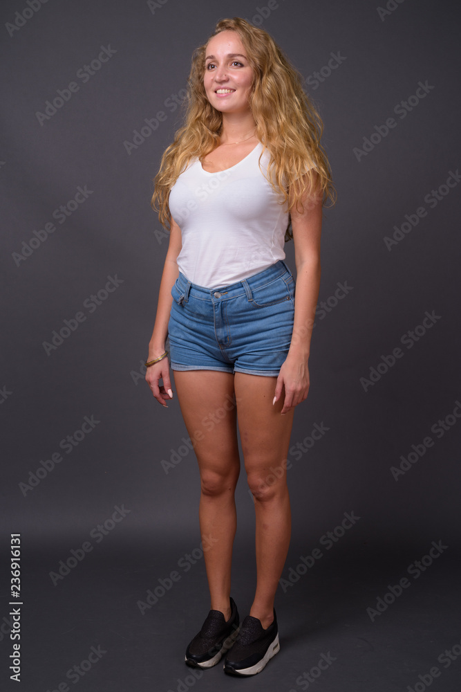 Full length portrait of young beautiful woman with long wavy blond hair Full length portrait of young beautiful woman with long wavy blond hair