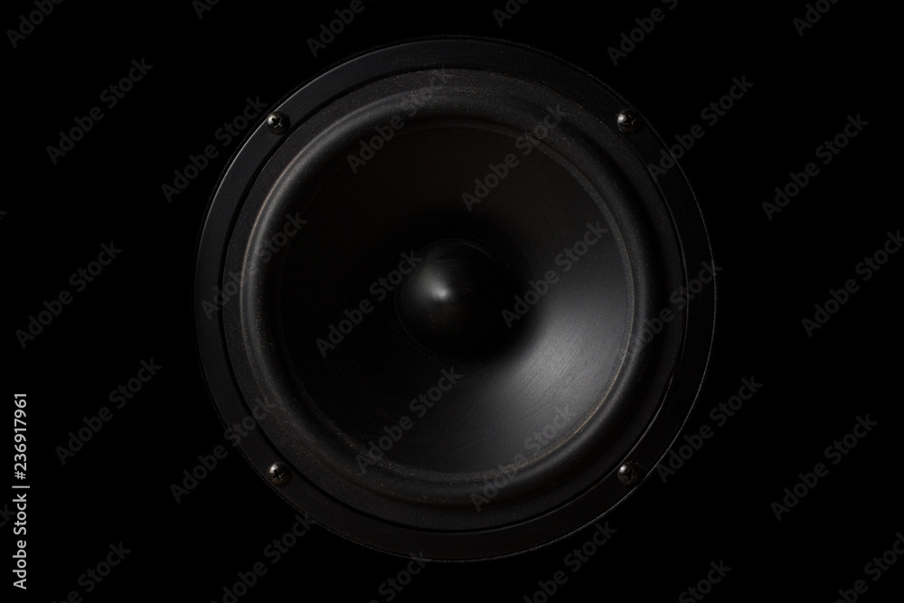 Black Music speaker on a black isolated background. Party or music listening concept Black Music speaker on a black isolated background. Party or music listening concept