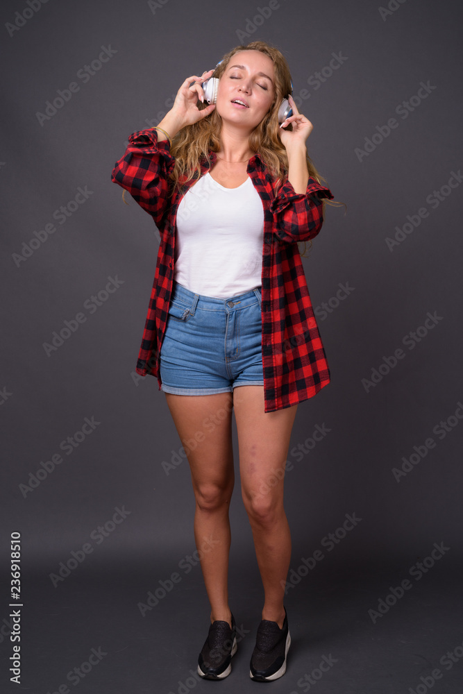 Full length portrait of young beautiful woman with long wavy blond hair Full length portrait of young beautiful woman with long wavy blond hair
