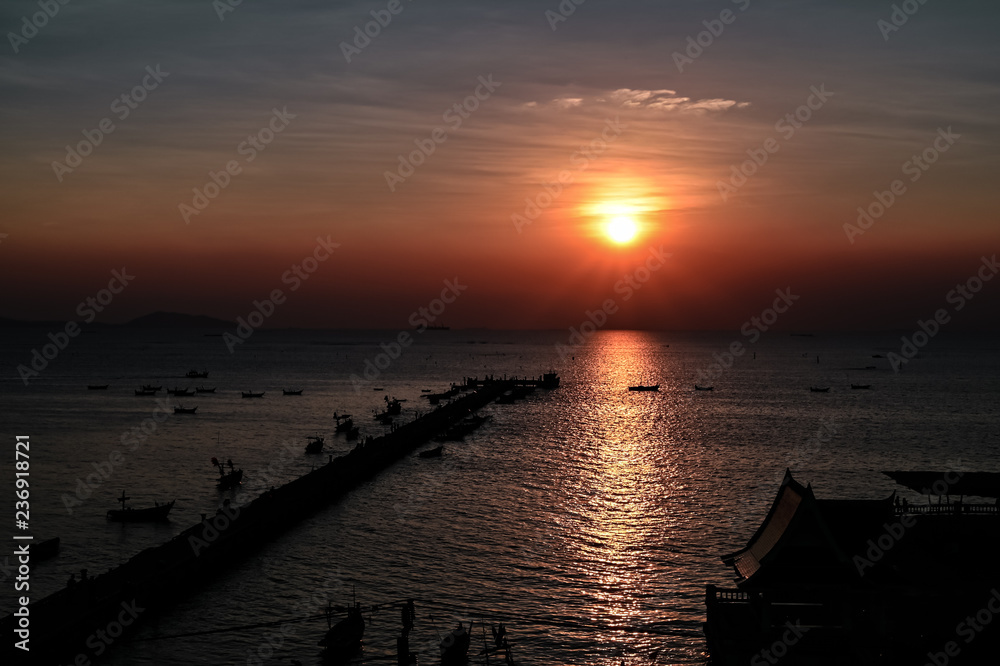 Sunset at the bridge by the sea with a boat surrounded. Sunset at the bridge by the sea with a boat surrounded.