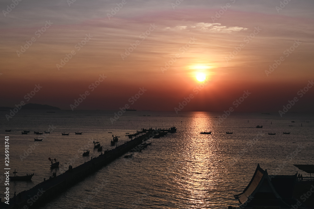 Sunset at the bridge by the sea with a boat surrounded. Sunset at the bridge by the sea with a boat surrounded.