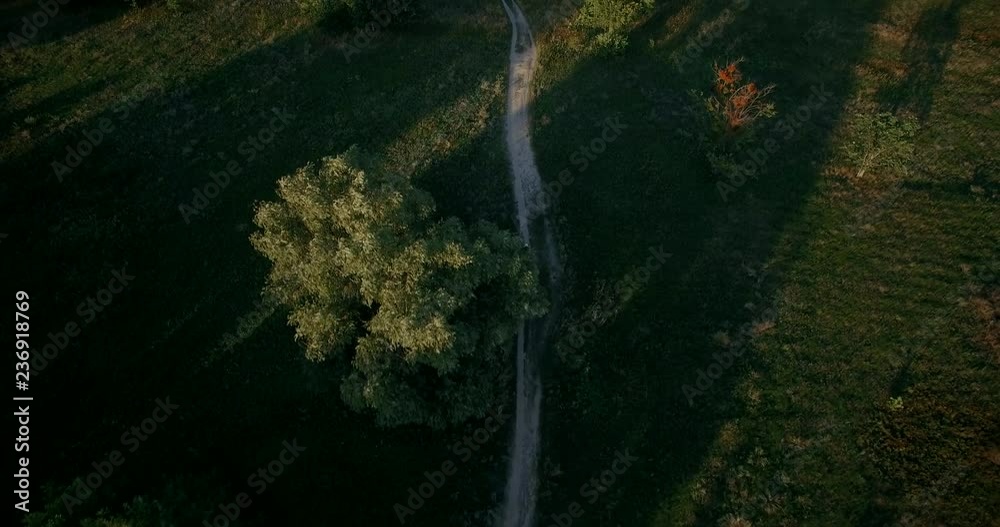 Cycling Aerial. Cyclist From Drone. MTB Cyclist Aerial View.Man Ride Bike On Rural Road.Healthy man cycling MTB bicycle outdoors fitness. Cycling Aerial. Cyclist From Drone. MTB Cyclist Aerial View.Man Ride Bike On Rural Road.Healthy man cycling MTB bicycle outdoors fitness.