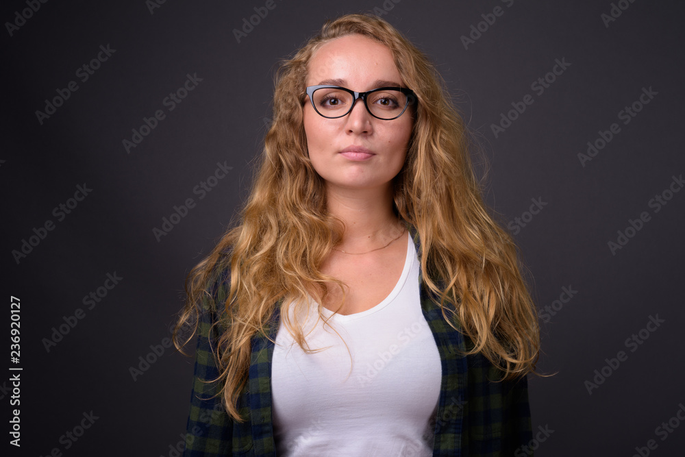 Portrait of young beautiful woman with long wavy blond hair Portrait of young beautiful woman with long wavy blond hair