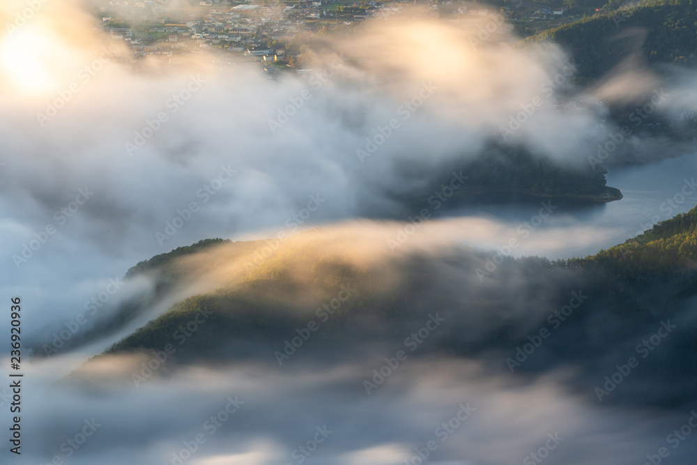 Morning mist over Kawaguchi lake closed to Fuji mountain