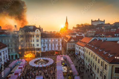 Fire and Smoke in Historical Building on Main Square, Bratislava, Slovakia at Sunset with Several Landmarks in Background