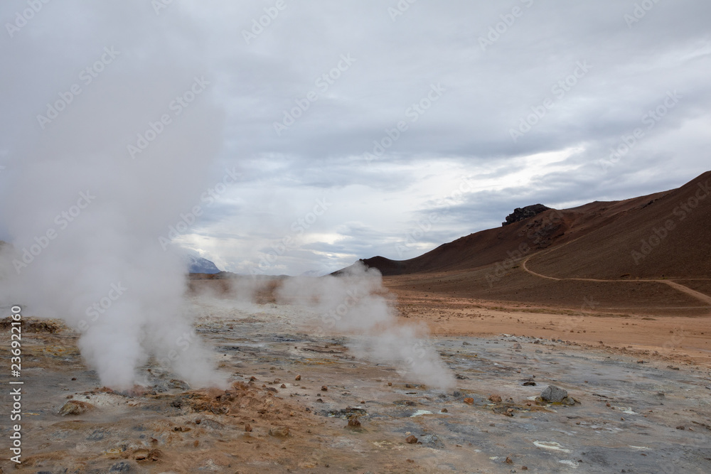Geothermal fields Iceland Europe. Geysers and fumaroles emit white cloud of steam
