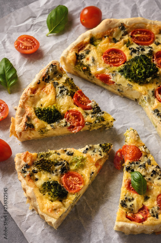 Homemade tart with broccoli, tomatoes and blue cheese.