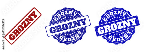 GROZNY scratched stamp seals in red and blue colors. Vector GROZNY labels with scratced effect. Graphic elements are rounded rectangles, rosettes, circles and text labels.