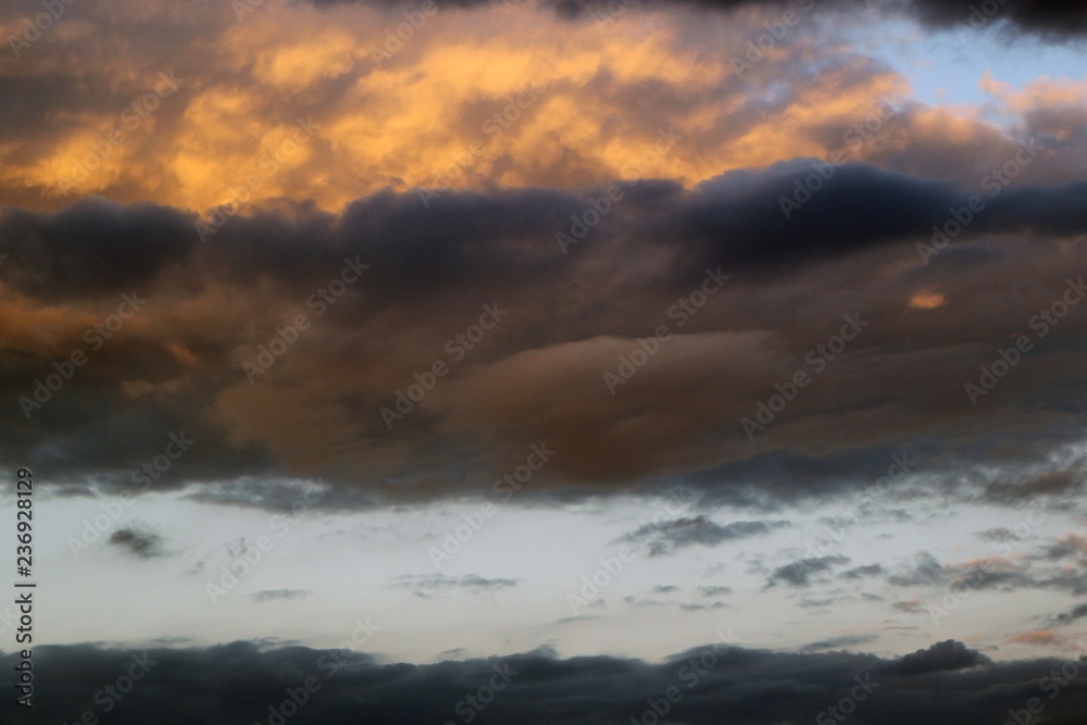 beautiful bright sun colored clouds on the sky for using in design as background.