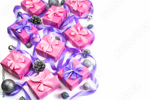 Christmas boxes with gifts on the occasion of pink color on white background cones nuts decor Top view flat lay horizontal Selective focus