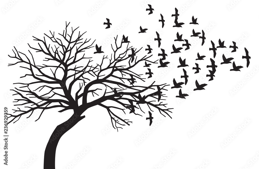 scary bare black tree silhouette and flock of flying birds
