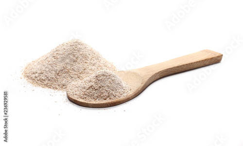 Pile of integral wheat flour with wooden spoon isolated on white