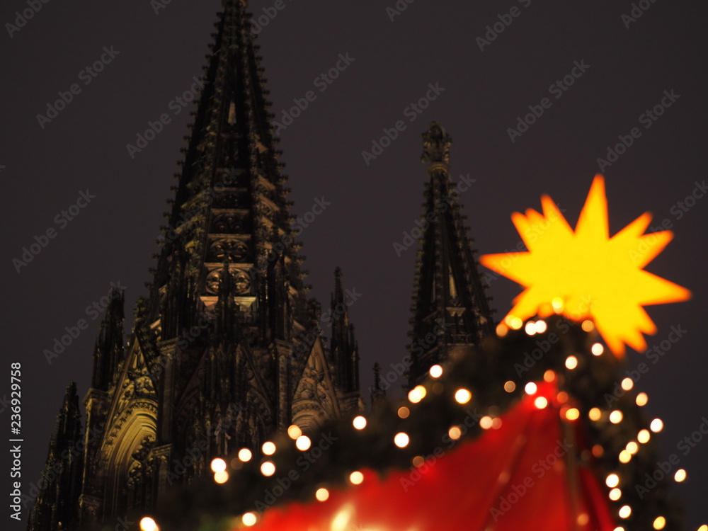 Christmas market in Cologne, Germany with the Cologne Cathedral in the background.