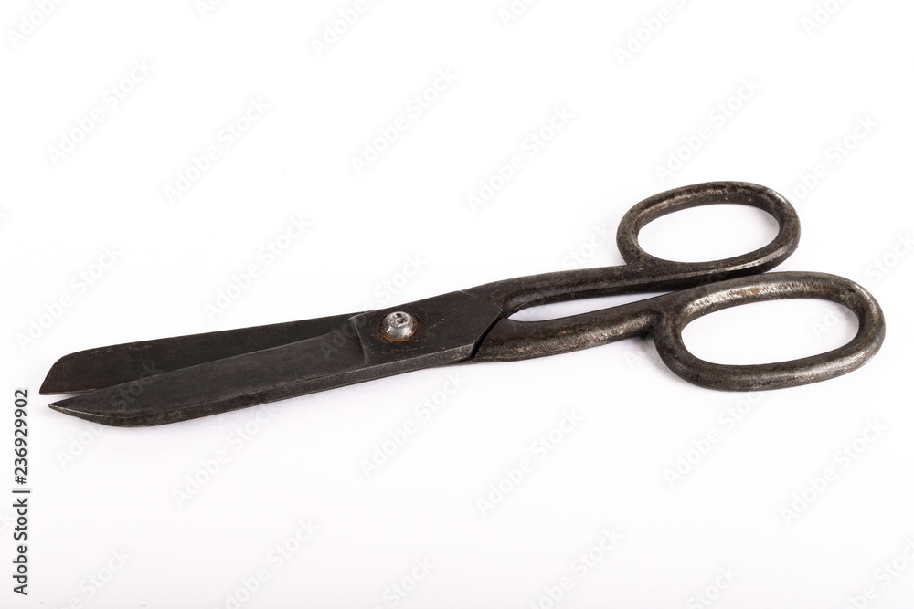 Old metal scissors on a light background