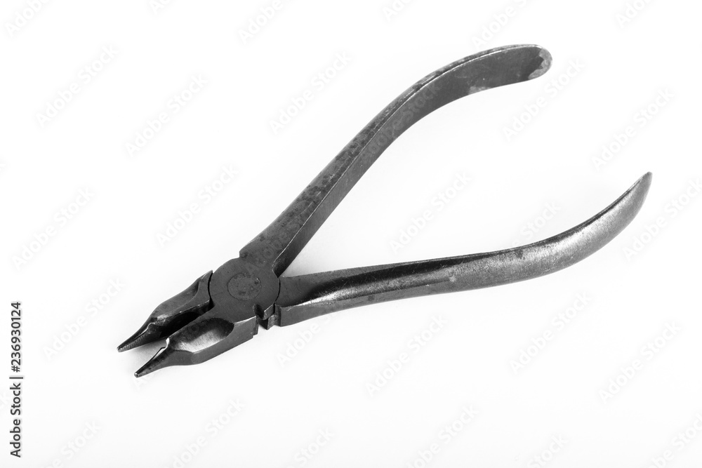 Old metal pliers on a light background