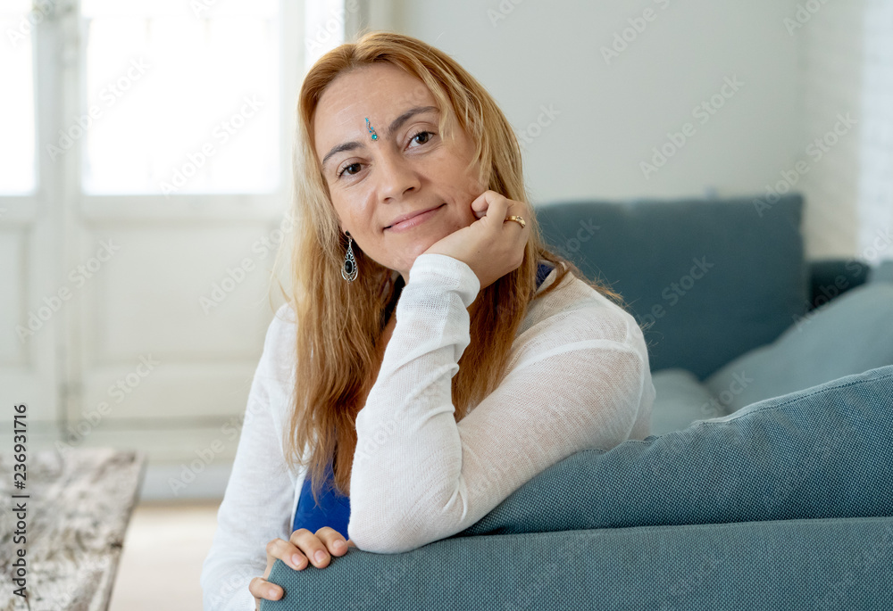 Happy attractive woman with bindi in forehead symbol of third eye chakra in Yoga and mindfulness.
