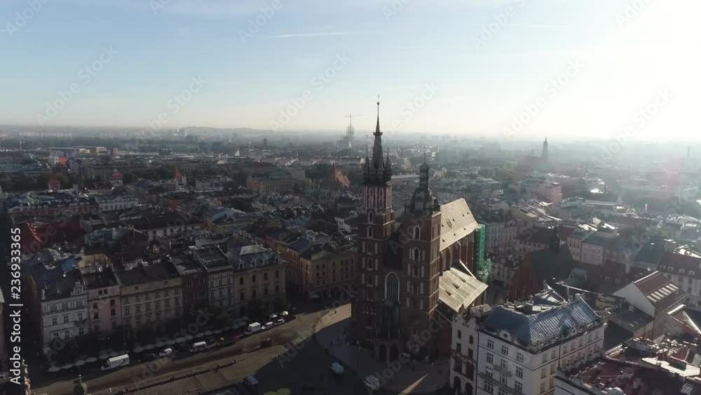 Old city center view with Adam Mickiewicz monument and St. Mary's Basilica in Krakow on the morning, aerial Old city center view with Adam Mickiewicz monument and St. Mary's Basilica in Krakow on the morning, aerial
