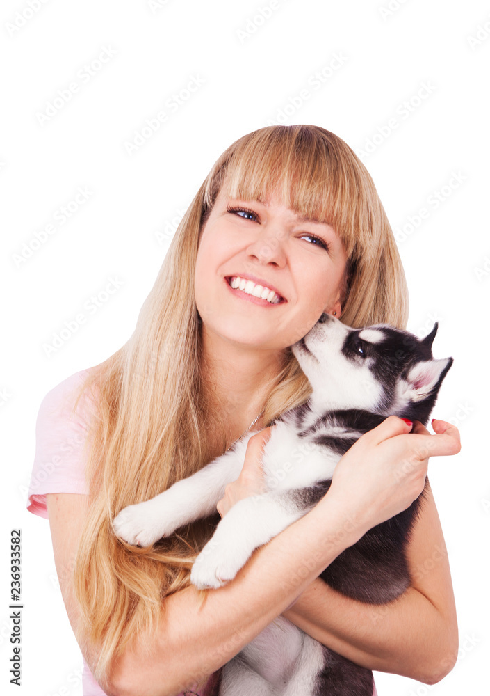 Happy women with her puppy Husky in the studio.