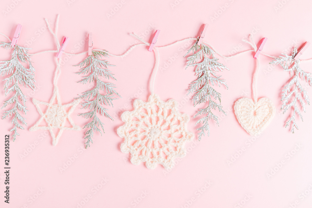 Christmas composition of crocheted white snowflakes and stars on pink background. Top view, flat lay, copy space. Christmas composition of crocheted white snowflakes and stars on pink background. Top view, flat lay, copy space.