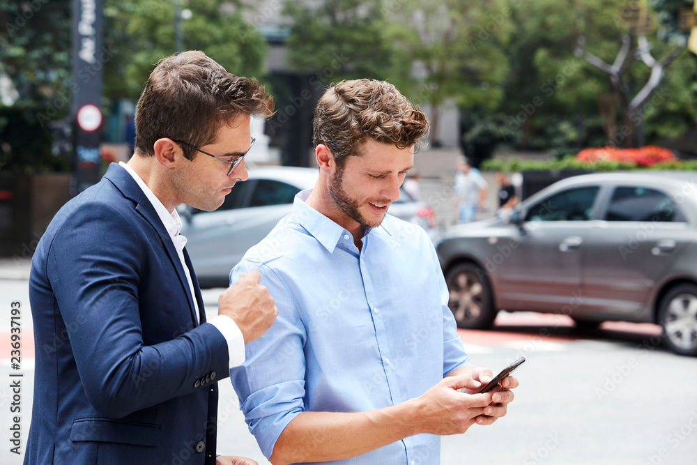 City dudes checking smartphone City dudes checking smartphone