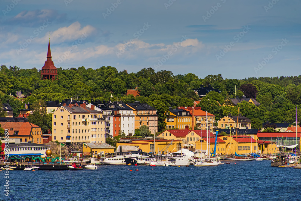 Obraz premium Scenic summer view of the Old Town pier architecture in Stockholm. Stockholm harbor Sweden